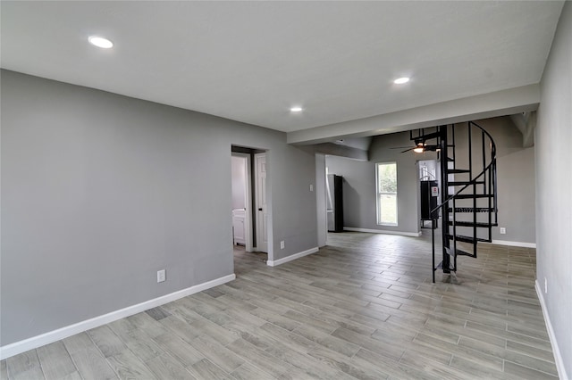 empty room featuring ceiling fan and light hardwood / wood-style floors