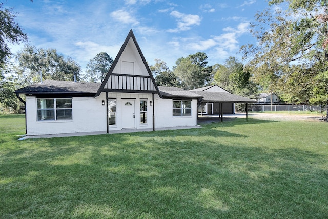 back of property featuring a yard