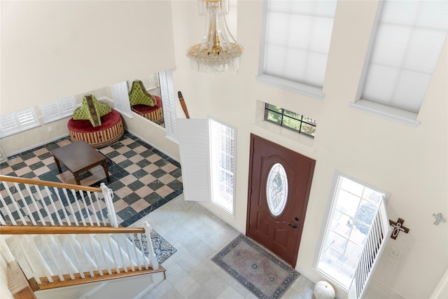 foyer featuring a high ceiling and a chandelier