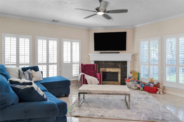 living room featuring a textured ceiling, a fireplace, plenty of natural light, and crown molding