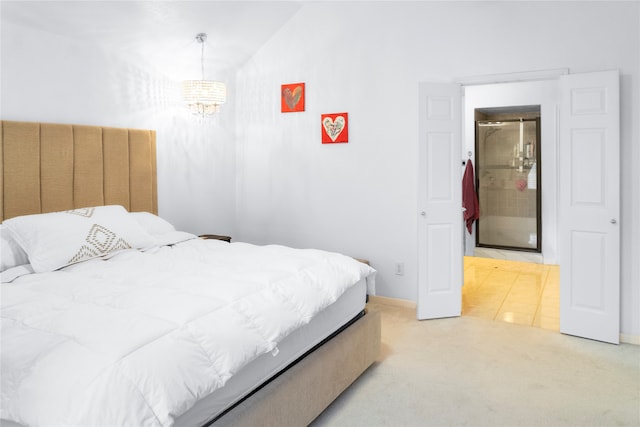 bedroom featuring vaulted ceiling, a chandelier, and carpet flooring