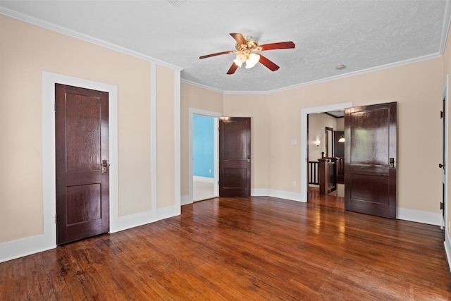 empty room featuring ornamental molding, ceiling fan, dark hardwood / wood-style floors, and a textured ceiling