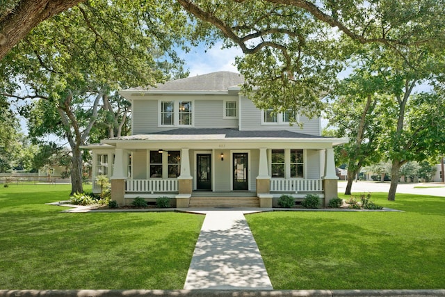 view of front of home with a front yard and a porch