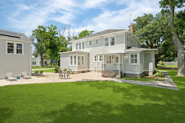 back of house with a lawn and a patio area