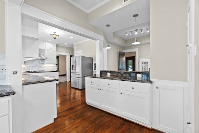 kitchen featuring dark stone countertops, dark hardwood / wood-style flooring, white cabinetry, decorative light fixtures, and stainless steel refrigerator with ice dispenser