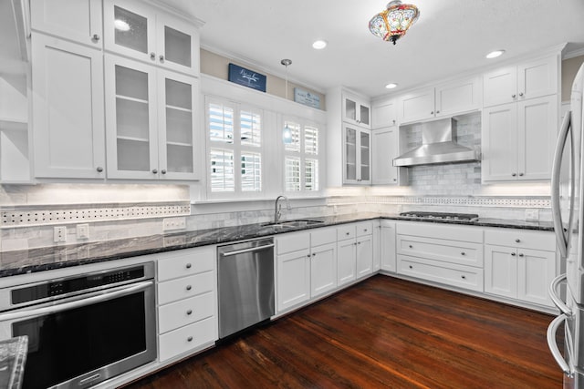 kitchen featuring dark hardwood / wood-style floors, stainless steel appliances, white cabinets, sink, and extractor fan