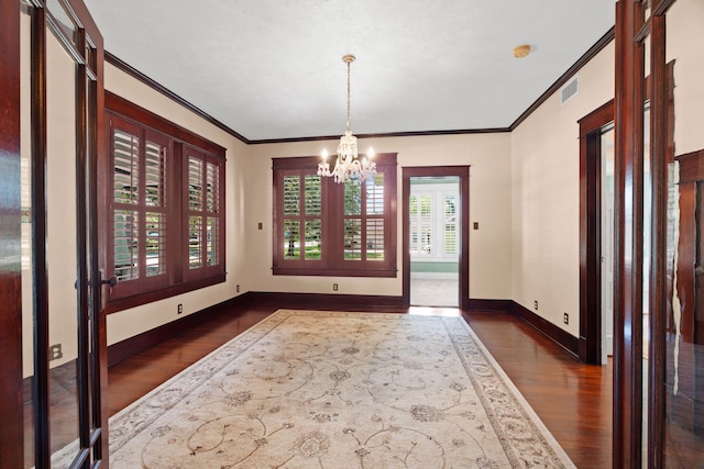 interior space with an inviting chandelier, crown molding, and dark wood-type flooring