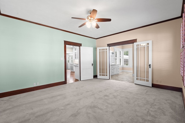 603 Hardeman St, Sealy, TX 77474 - unfurnished bedroom with carpet floors, ceiling fan, baseboards, french doors, and crown molding