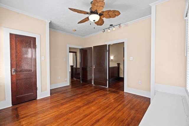 unfurnished bedroom with ornamental molding, ceiling fan, dark hardwood / wood-style floors, and a textured ceiling