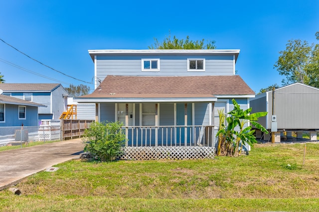 view of front of home with a front lawn, a porch, and central AC unit