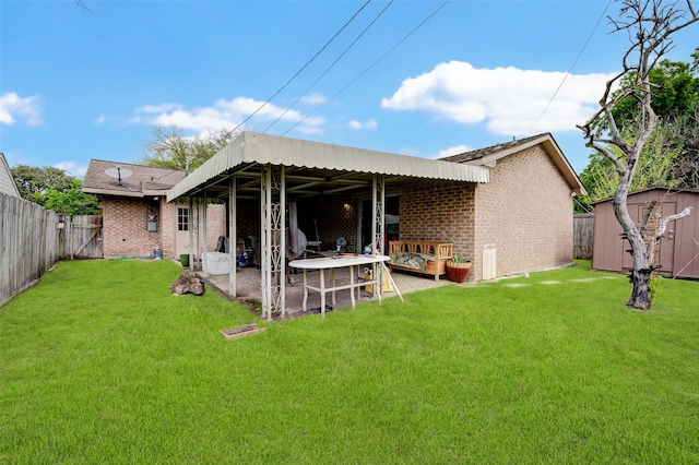 back of house featuring a lawn, a patio, and a shed