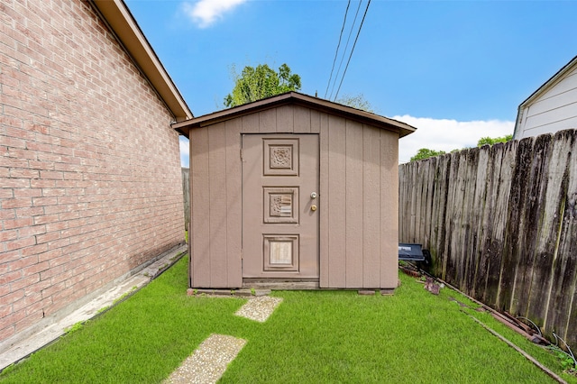 view of outbuilding featuring a lawn