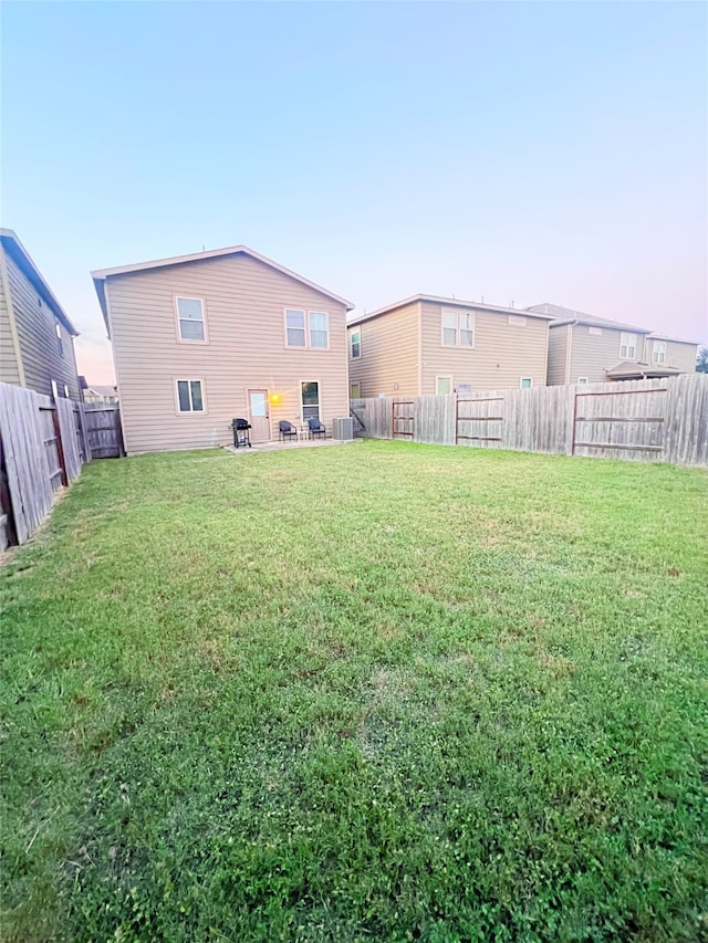 yard at dusk with central AC