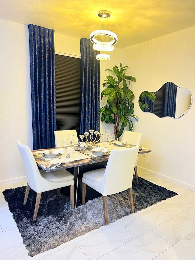 dining area featuring a notable chandelier