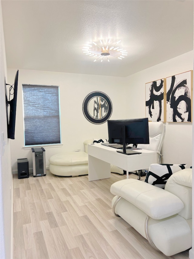 living room with a textured ceiling and light hardwood / wood-style flooring