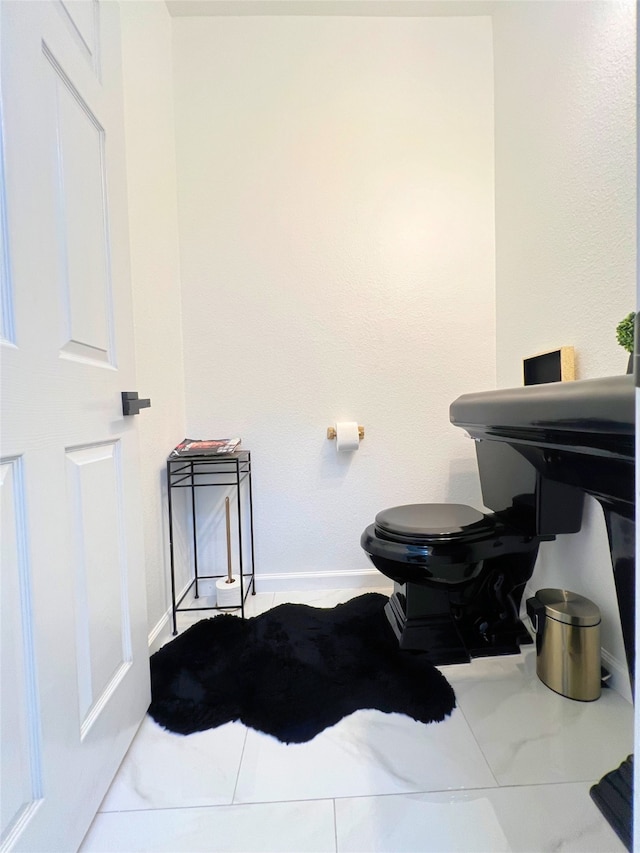 bathroom featuring tile patterned flooring and toilet