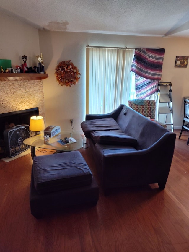 living room with a textured ceiling and wood-type flooring