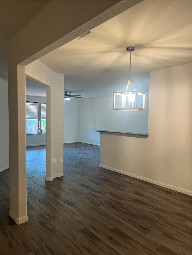 unfurnished room featuring dark wood-type flooring and ceiling fan