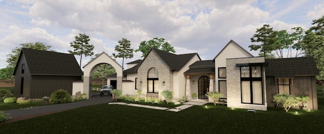 view of front of house featuring a front lawn and stone siding
