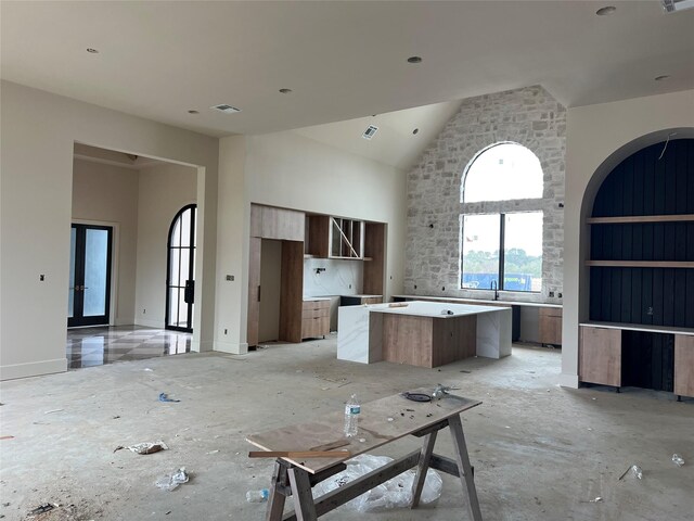 kitchen featuring a towering ceiling and a kitchen island