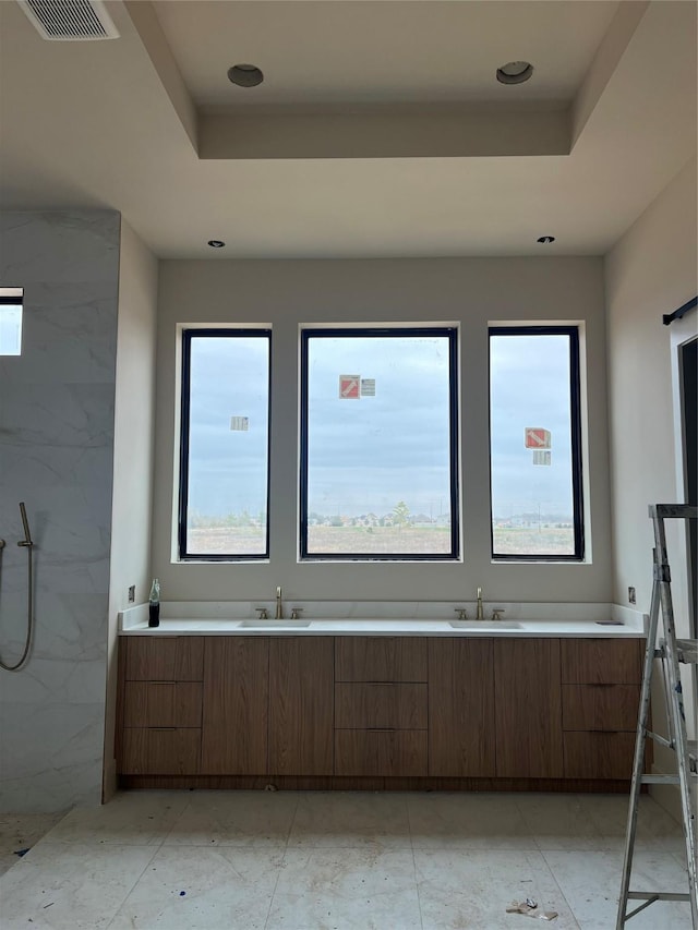 bathroom featuring a raised ceiling, plenty of natural light, and independent shower and bath