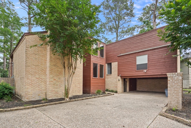 view of front of property with a carport and a garage