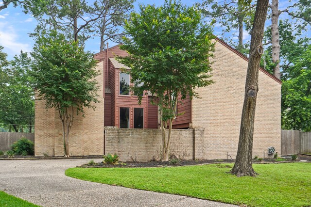 view of side of home with a yard