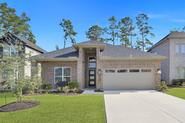 view of front of property with a front yard and a garage