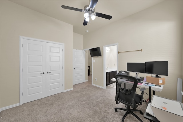 carpeted office featuring ceiling fan