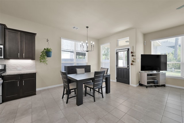 dining room featuring a chandelier and light tile patterned floors