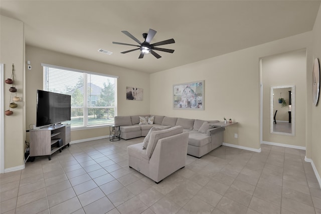 living room featuring light tile patterned floors and ceiling fan