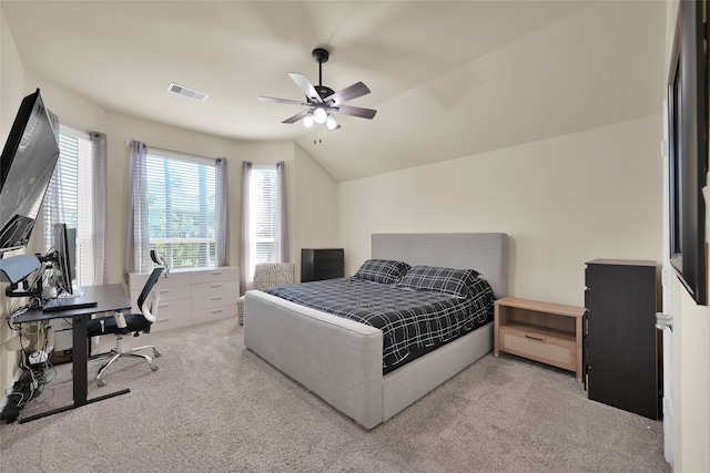 bedroom with lofted ceiling, ceiling fan, and light colored carpet