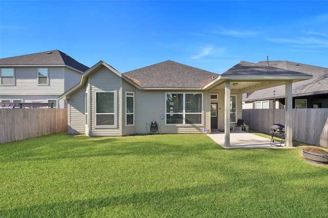 back of house featuring a patio and a yard