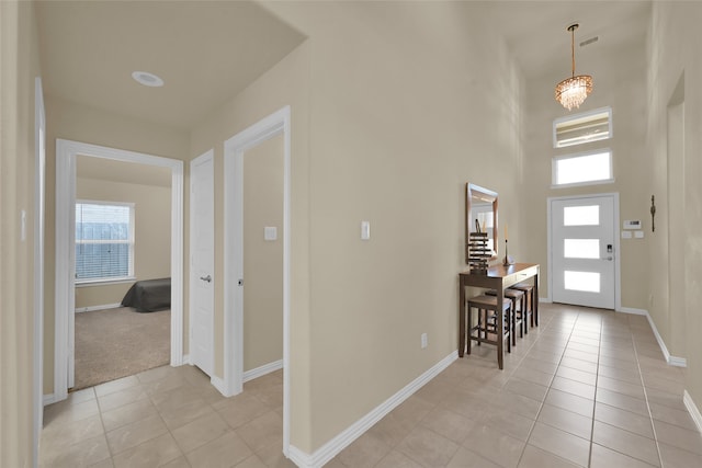 tiled foyer featuring a towering ceiling