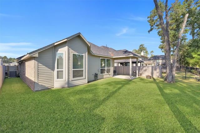 back of property with a patio, a yard, and cooling unit