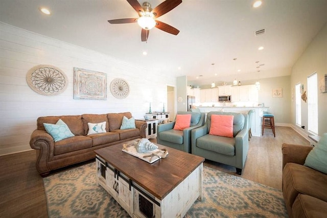 living room with wood-type flooring and ceiling fan