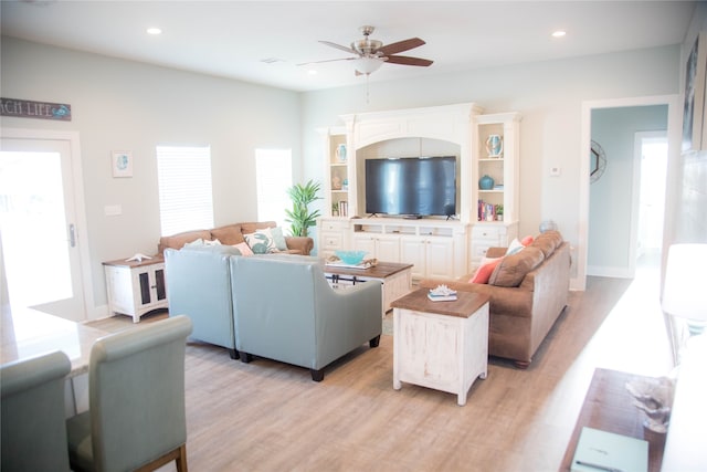 living room featuring ceiling fan and light hardwood / wood-style flooring