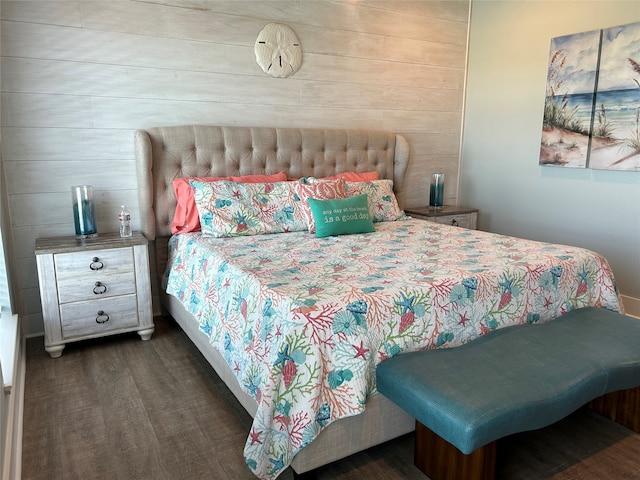 bedroom featuring wood walls and dark hardwood / wood-style flooring