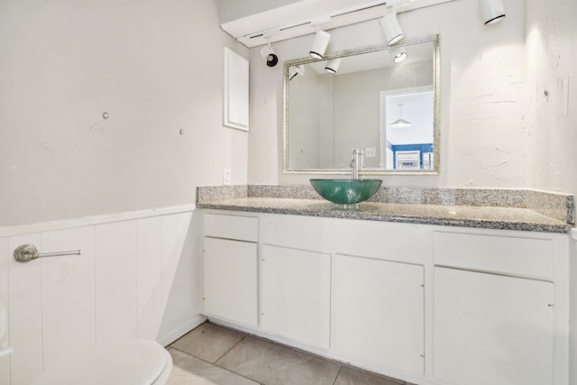 bathroom with vanity, toilet, and tile patterned floors