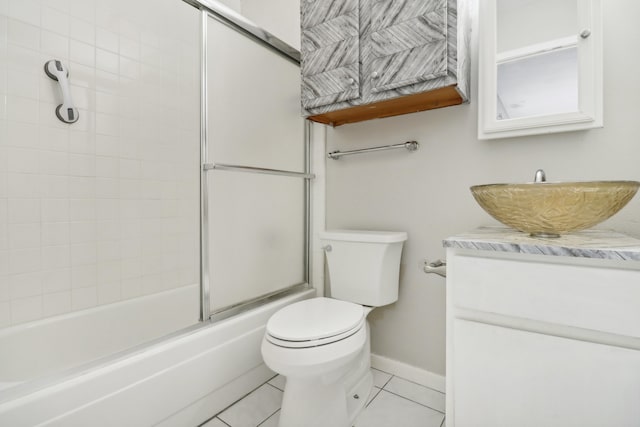 full bathroom featuring enclosed tub / shower combo, tile patterned floors, vanity, and toilet