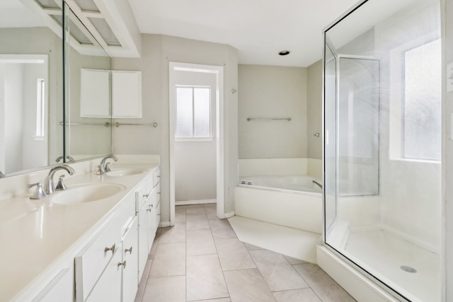 bathroom featuring plus walk in shower, tile patterned floors, and vanity