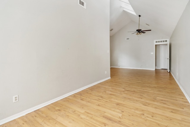 spare room featuring light hardwood / wood-style floors, high vaulted ceiling, and ceiling fan