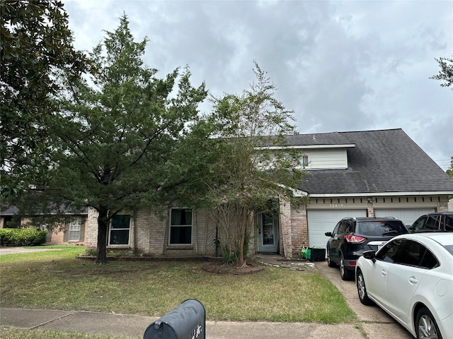 12419 Longbrook Dr, Houston, TX 77099 - view of property hidden behind natural elements featuring brick siding, an attached garage, a front yard, and roof with shingles