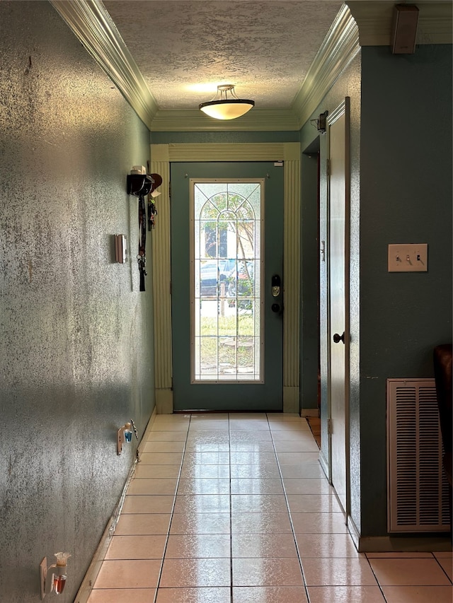 doorway to outside with ornamental molding and light tile patterned floors