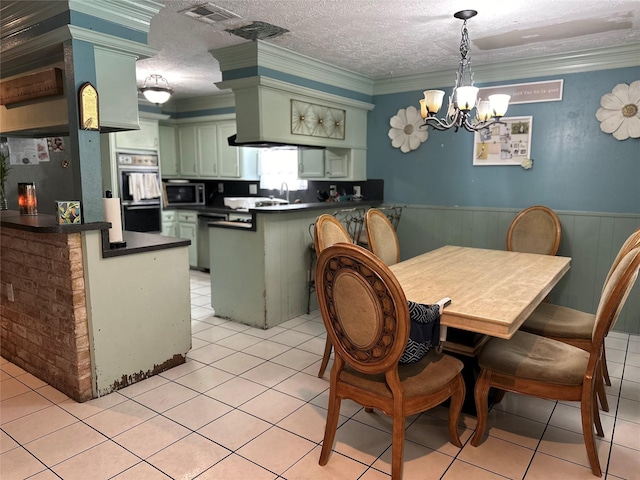 12419 Longbrook Dr, Houston, TX 77099 - dining space featuring crown molding, a chandelier, visible vents, and a wainscoted wall