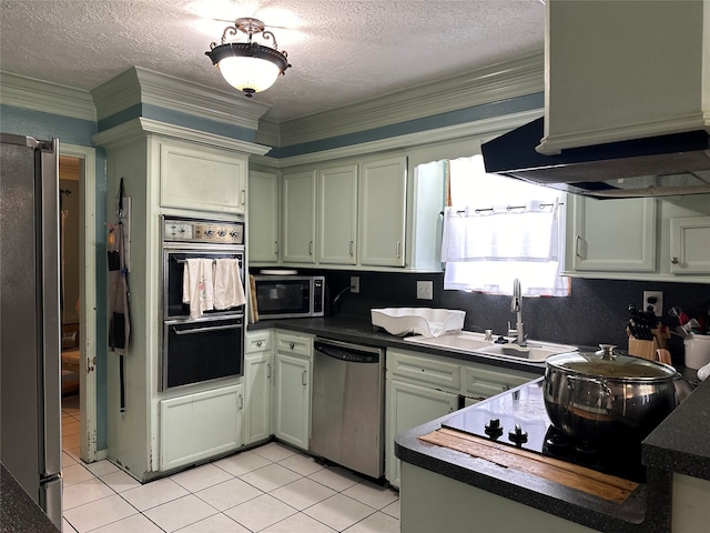 kitchen with light tile patterned floors, stainless steel appliances, a textured ceiling, ornamental molding, and sink