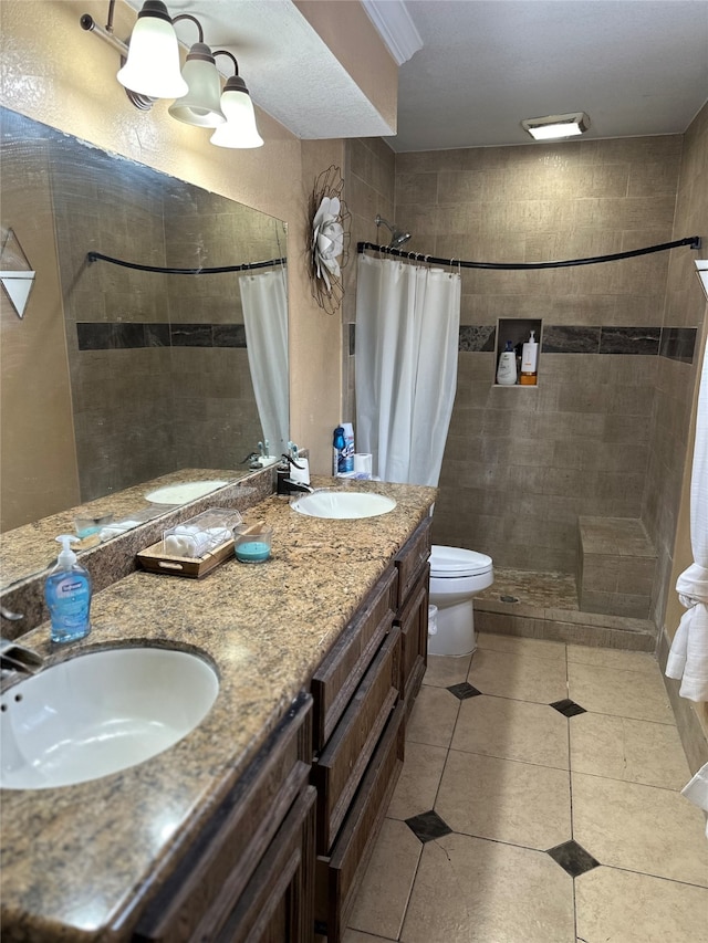 bathroom featuring tile patterned flooring, a shower with curtain, vanity, and toilet