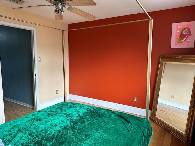 unfurnished bedroom with ceiling fan and hardwood / wood-style flooring