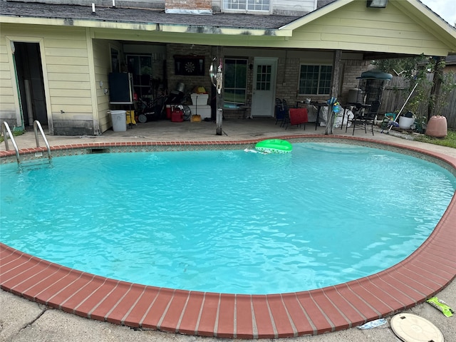 view of swimming pool with a patio area