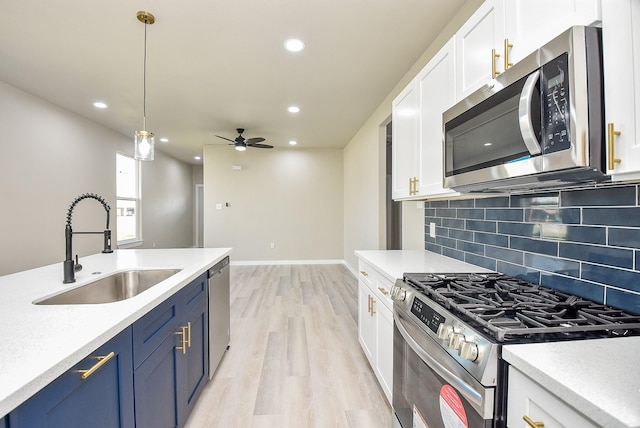 kitchen featuring a sink, light countertops, white cabinets, and stainless steel appliances